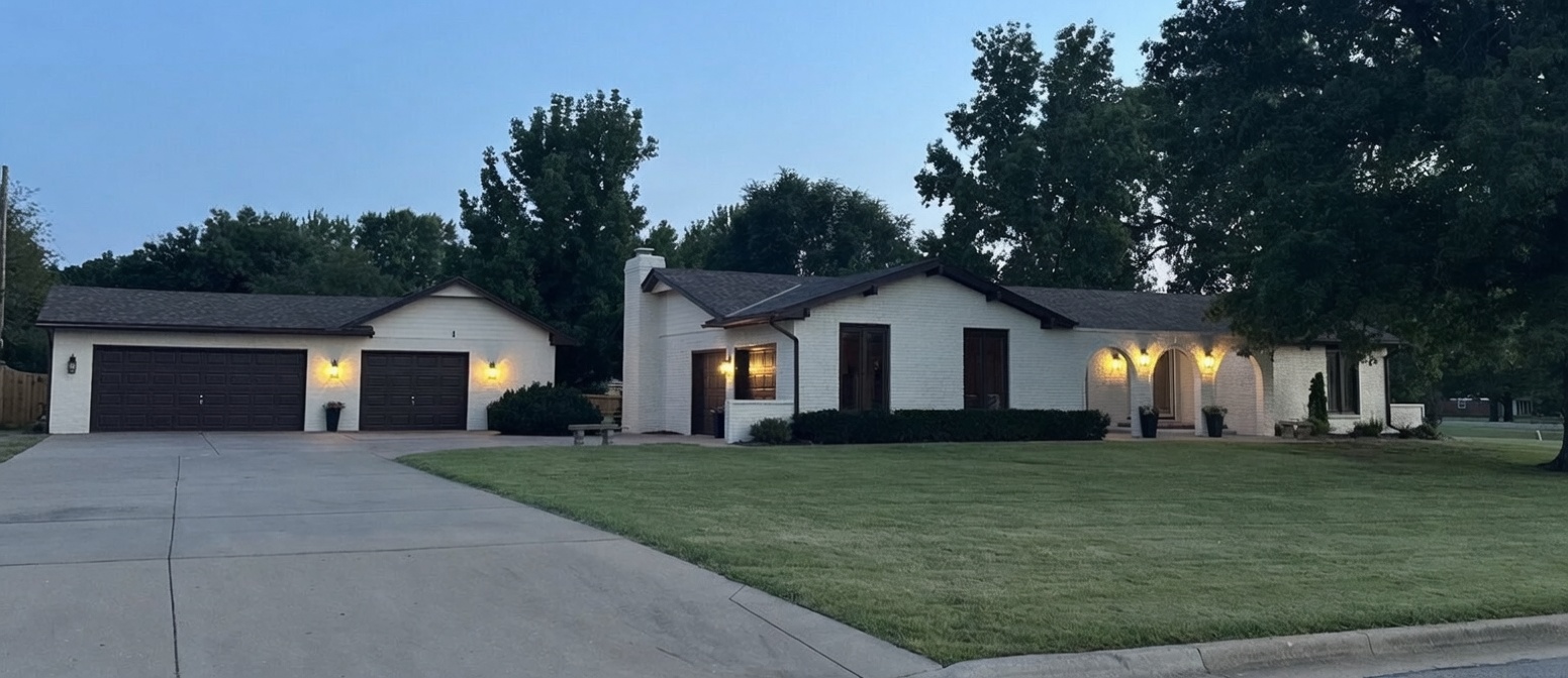Twilight exterior showing the home and detached shop at 1 Woodland Drive