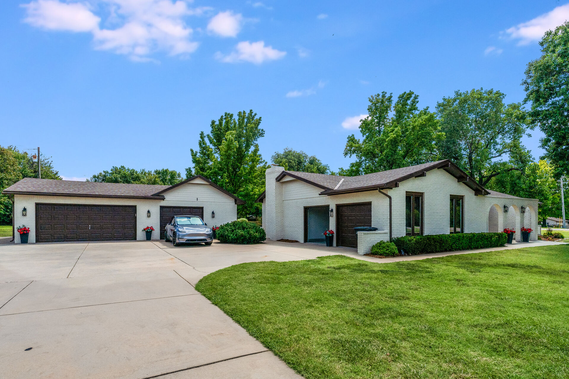 Driveway view of the detached shop and attached garage at 1 Woodland Drive